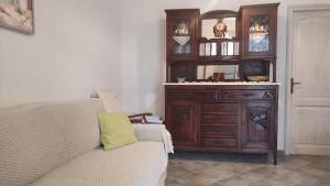 a living room with a couch and a wooden dresser at Maria's Apartment Sifnos in Kamares