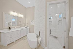 a white bathroom with a toilet and a shower at 298 5 Bedrooms Fenced yard New Construction in Robstown