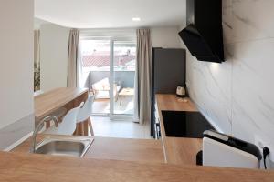 a kitchen and dining room with a table and chairs at SPA Apartment Mediterano in Rijeka