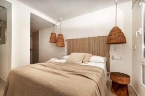 a bedroom with a large bed and two pendant lights at eme de Maison - luxury only two in Arenales del Sol +38 photos