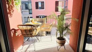 a patio with a table and chairs and a plant at SEAESTA Cosy Sea Apartment in Koper +15 photos