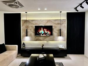 a living room with a couch and a fireplace at The Chess Lounge with Pool & Gym in Islamabad