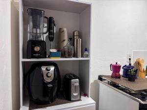 a kitchen with a blender on a shelf at Jardim da Música Tiradentes in Tiradentes