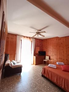 a bedroom with a bed and a ceiling fan at Il Campanile Civico 35 in Aieta
