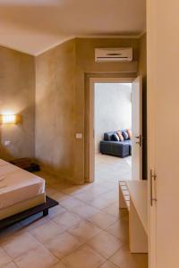 a bedroom with a bed and a couch in a room at Aparthotel Tropical Bounty Beach T3 in Santa Maria