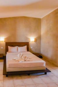 a bedroom with a bed with two towels on it at Aparthotel Tropical Bounty Beach T3 in Santa Maria +26 photos