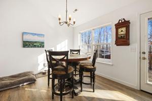 a dining room with a table and chairs and a clock at Rockrider House-MTB Trail-Pet Friendly in Bella Vista