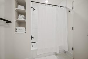 a white bathroom with a shower and white towels at Mountain View Golf Haven Pt C105 Wkly Disc in Eden