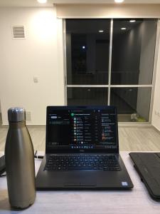 a laptop computer sitting on top of a table with a vase at Quedate con Yey in Chía