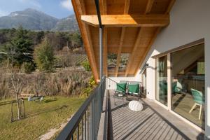 a balcony of a house with green chairs on it at San Antonia in Caldaro