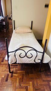 a bed sitting on top of a wooden floor at Departamento Encantador in La Paz