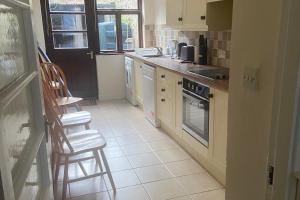 a kitchen with a counter and chairs in it at Hannah in Cashel