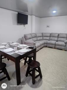 a living room with a table and a couch at Apartamento el Rubí 202 in Cómbita