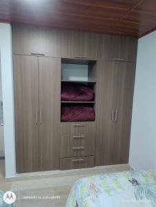 a bedroom with wooden cabinets and a bed at Apartamento el Rubí 202 in Cómbita