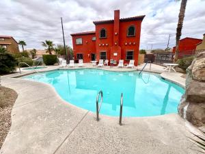 a large swimming pool with a building in the background at Supreme updated Hawkridge Condo in Mesquite