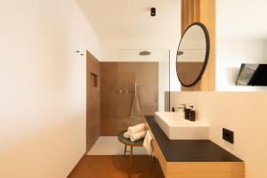 a bathroom with a sink and a mirror at San Antonia in Caldaro +32 photos