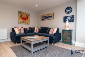 a living room with a couch and a table at Stylish Sanctuary - Estuary Views - Outside Space in Salcombe