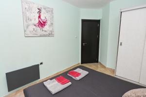 A bed or beds in a room at Eli Apartment Burgas Center