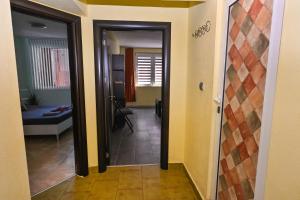 A bed or beds in a room at Eli Apartment Burgas Center