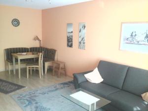 ein Wohnzimmer mit einem Sofa und einem Tisch in der Unterkunft Appartement Haus Hamburg in Bad Füssing