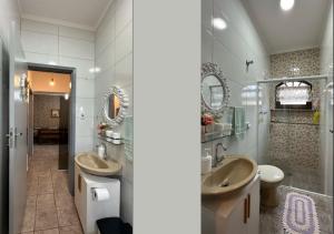 ein Badezimmer mit zwei Waschbecken und zwei Spiegeln in der Unterkunft Cantinho aconchegante da Família Moreira na Praia das Palmeiras in Caraguatatuba + 37 Fotos