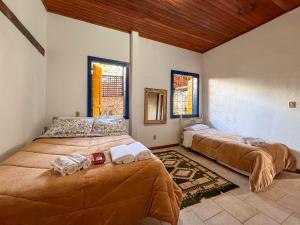 a bedroom with two beds in a room at Jardim da Música Tiradentes in Tiradentes
