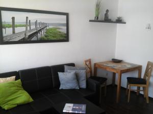a living room with a couch and a table at Appartement Haus Hamburg in Bad Füssing