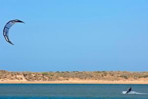 a man is kite surfing in the water at Kimpton Atlantico Algarve by IHG in Albufeira