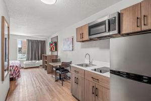 an apartment kitchen with a sink and a microwave at Red Roof Inn Southfield in Southfield