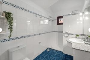 a white bathroom with a tub and a sink at Villa del Mar Palm Mar in Palm-mar +20 photos