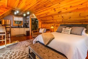 a bedroom with a bed in a room with wooden ceilings at Couples Carriage House Retreat-Wineries & Hiking in Dahlonega +13 photos