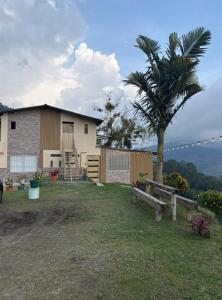 una casa con una palma nel cortile di Finca Hotel Los Felipes - Neira a Neira