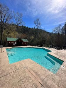 a large blue swimming pool with a red barn at Grand Lodge in Sevierville