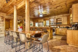 a kitchen with a large wooden table and chairs at Grand Lodge in Sevierville