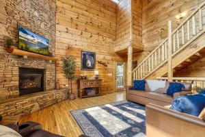 a living room with a fireplace in a log cabin at Grand Lodge in Sevierville