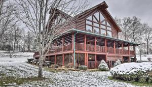 a large log cabin in the snow with a tree at Grand Lodge in Sevierville
