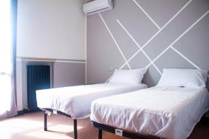 Postel nebo postele na pokoji v ubytování Camere della Perla