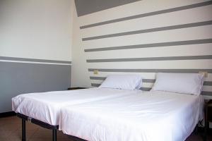 Postel nebo postele na pokoji v ubytování Camere della Perla
