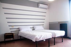 Postel nebo postele na pokoji v ubytování Camere della Perla