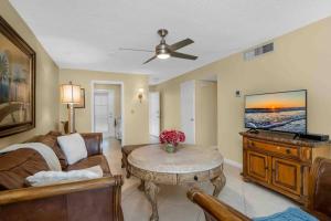 a living room with a couch and a table at Aqua Breeze in Naples