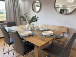 a dining room table with chairs and a mirror at Casa Clara - Exklusive Ferienwohnung in Hennweiler