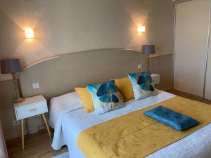 a bedroom with a large bed with two lamps at Appartement T2 sur le Golf de Saint Endréol,spa,piscine in La Motte +29 photos