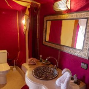 a bathroom with a sink and a mirror at Merzouga Beduien Camping in Merzouga +41 photos