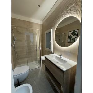 a bathroom with a sink and a toilet and a mirror at Salento Apartment in Brindisi