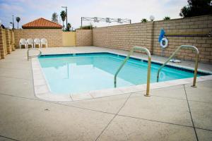 a swimming pool in a building with a brick wall at Crystal Inn Suites & Spas in Inglewood