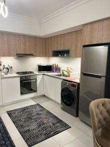 a kitchen with a refrigerator and a dishwasher at Chalet in marassi marina pool view exm80 in El Alamein