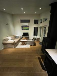 a living room with a couch and a table at Practical and cozy cottage in idyllic Senja in Senja +22 photos