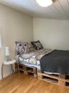 a bedroom with a bed and a lamp and a table at Practical and cozy cottage in idyllic Senja 3 bedrooms in Senja