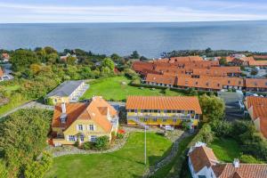 an aerial view of a village with houses and the ocean at Villa Koch X Pension Koch in Gudhjem