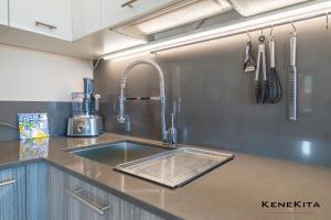 a kitchen with a sink and a counter top at MoonLight Sea in Pittulongu